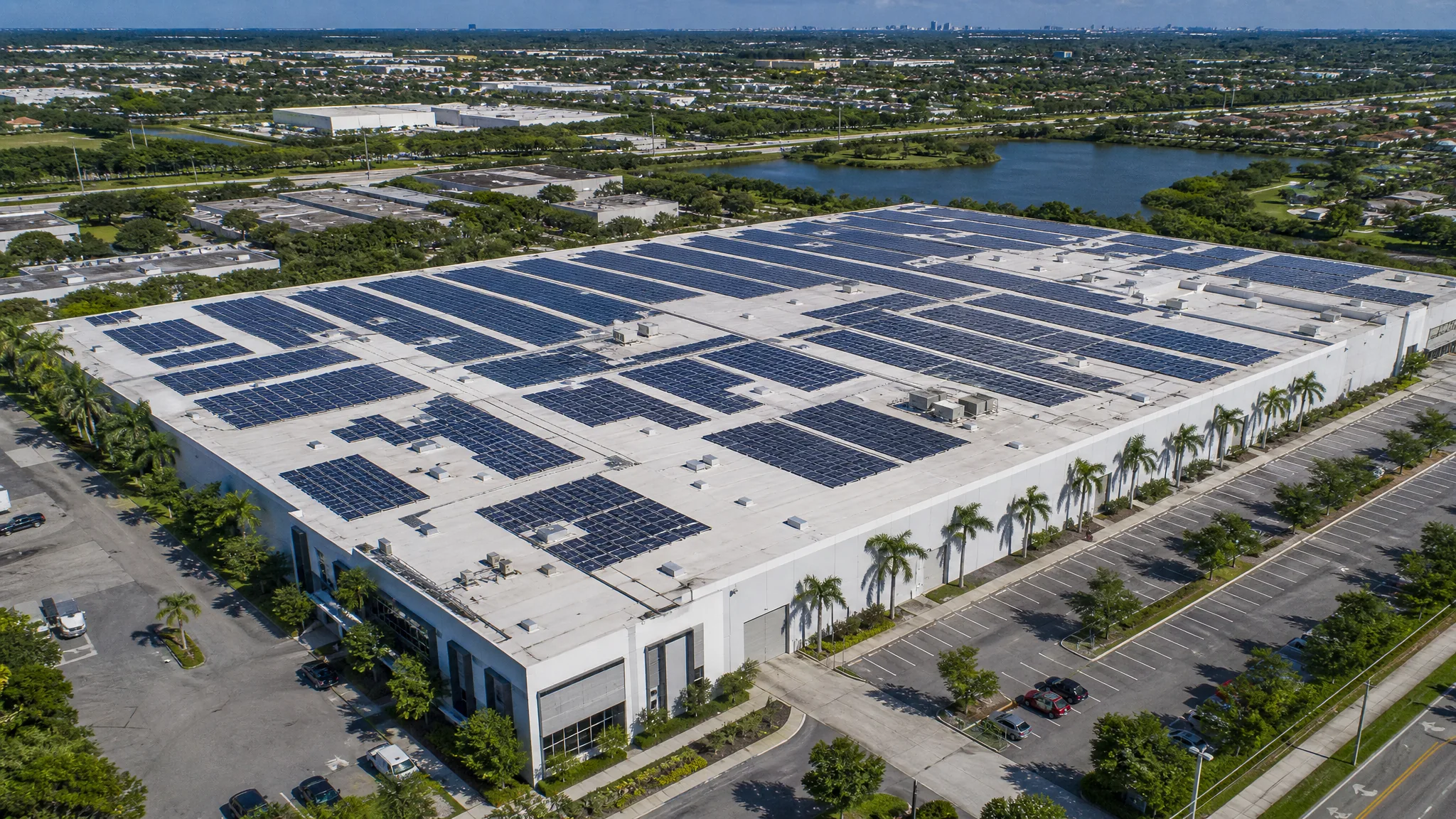 Aerial view of a large commercial rooftop solar installation
